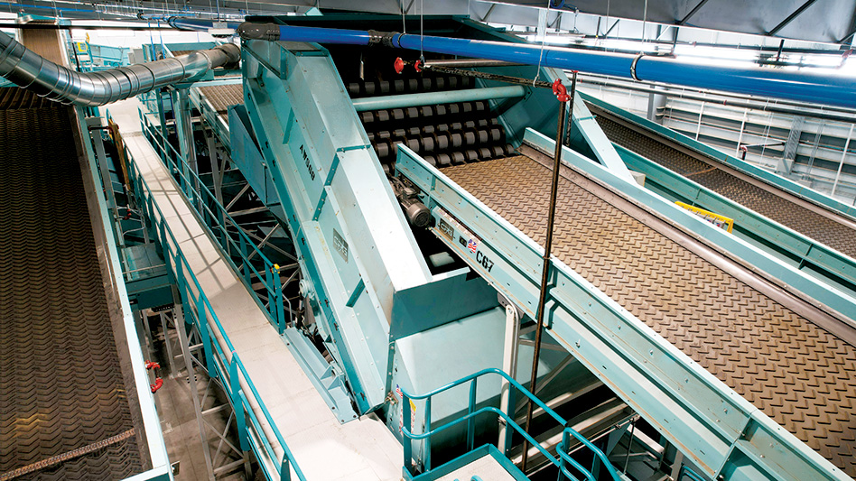 Close up of a conveyor belt and an anti-wrap disc screen equipment.