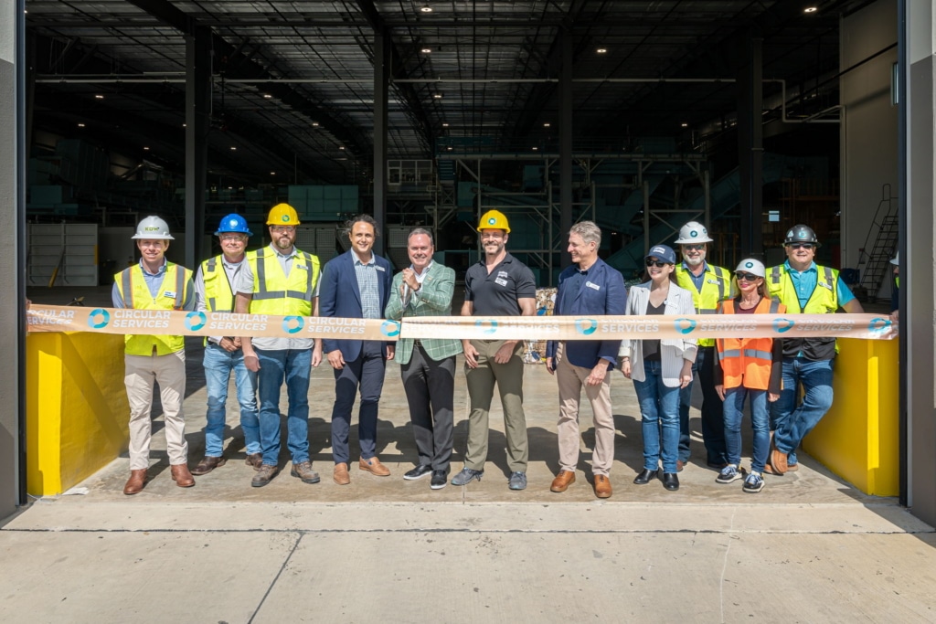 Group photo of the Circular Services team doing a ribbon cutting ceremony.