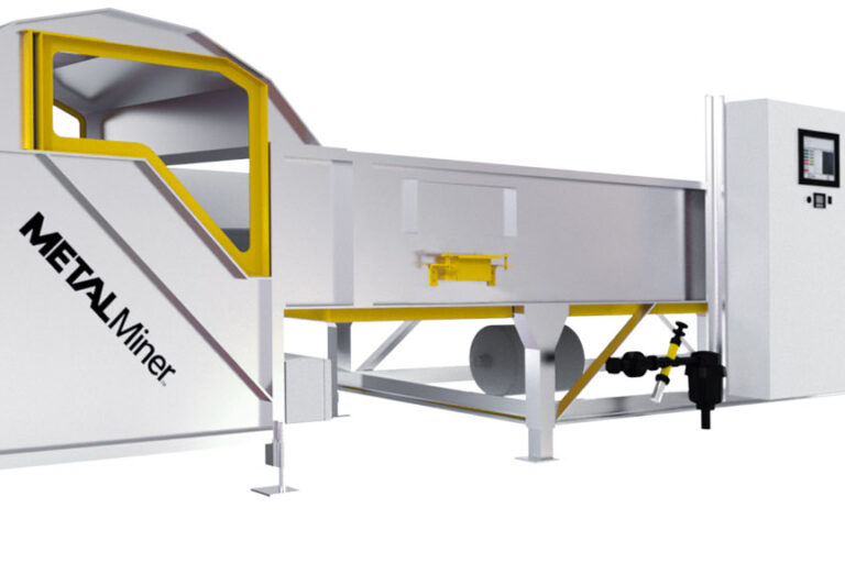 A large industrial optical sorting machine featuring a long conveyor belt and a control panel. The machine is primarily silver with yellow accents and labeled "METALMINER" on one side. It appears designed for processing or handling materials in a manufacturing setting.