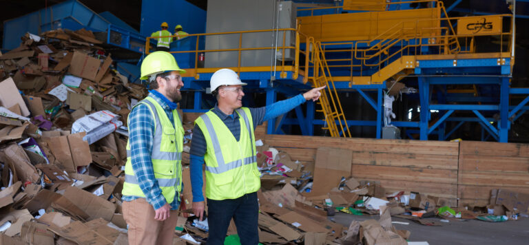 two men onsite with hardhats