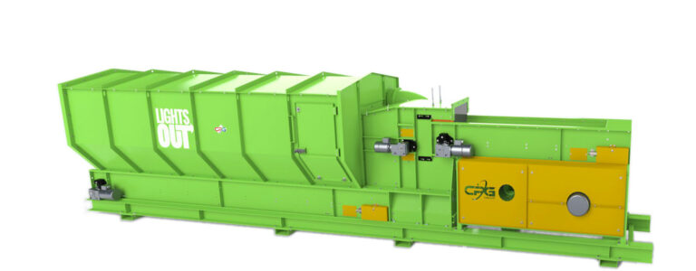 A lime green waste compactor with a yellow control panel featuring the logo "CPG". The machine has a labeled "LightsOut" on its side and multiple compartments and mechanisms visible. It is designed for industrial or commercial waste processing.