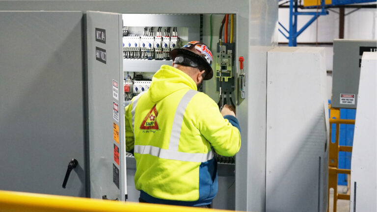 Guy working on electrical controls in a MRF