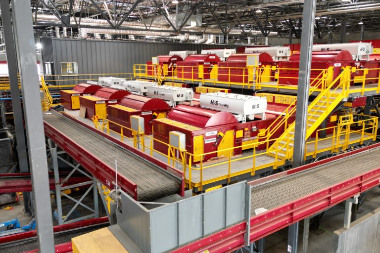 An image overview of red optical sorting equipment in a recycling facility.